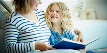 child-reads-social-story-with-mother